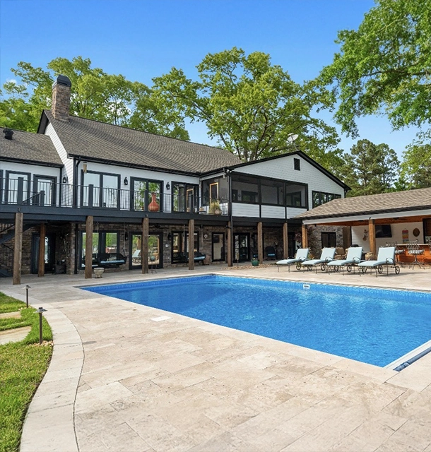 large rectangular pool behind a modern two-story home